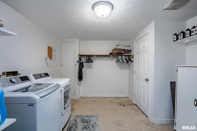a view of a balcony with chairs and umbrella
