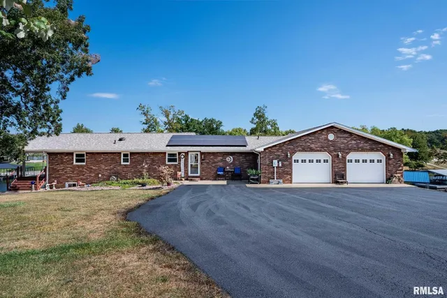 a view of a brick house with wooden fence