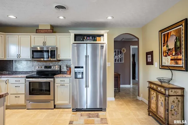 a living room with furniture a flat screen tv and a large window