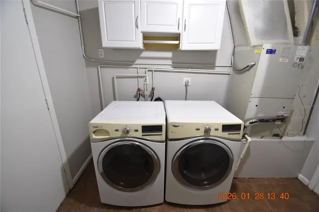 a view of a room with wooden floor and windows