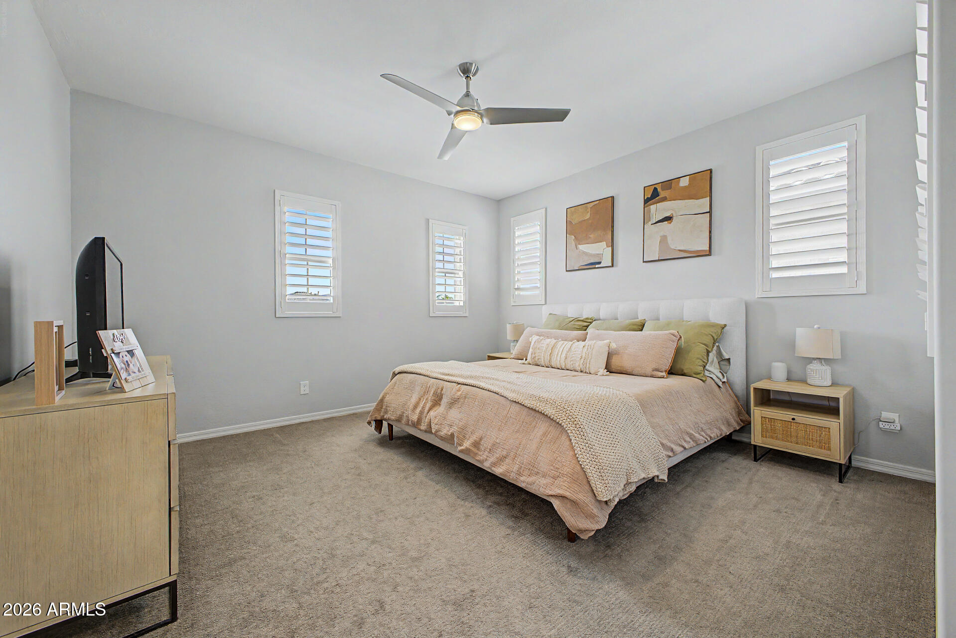 2583 South Entwistle Street Gilbert, AZ 85295 - Photo 12 of 42 a bed room with a bed and a chandelier