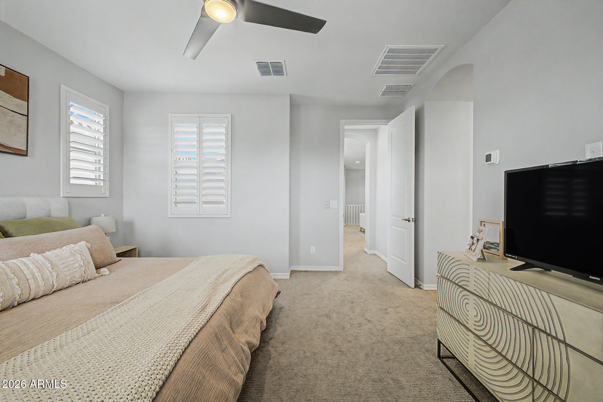2583 South Entwistle Street Gilbert, AZ 85295 - Photo 13 of 42 a bedroom with a bed and a flat screen tv