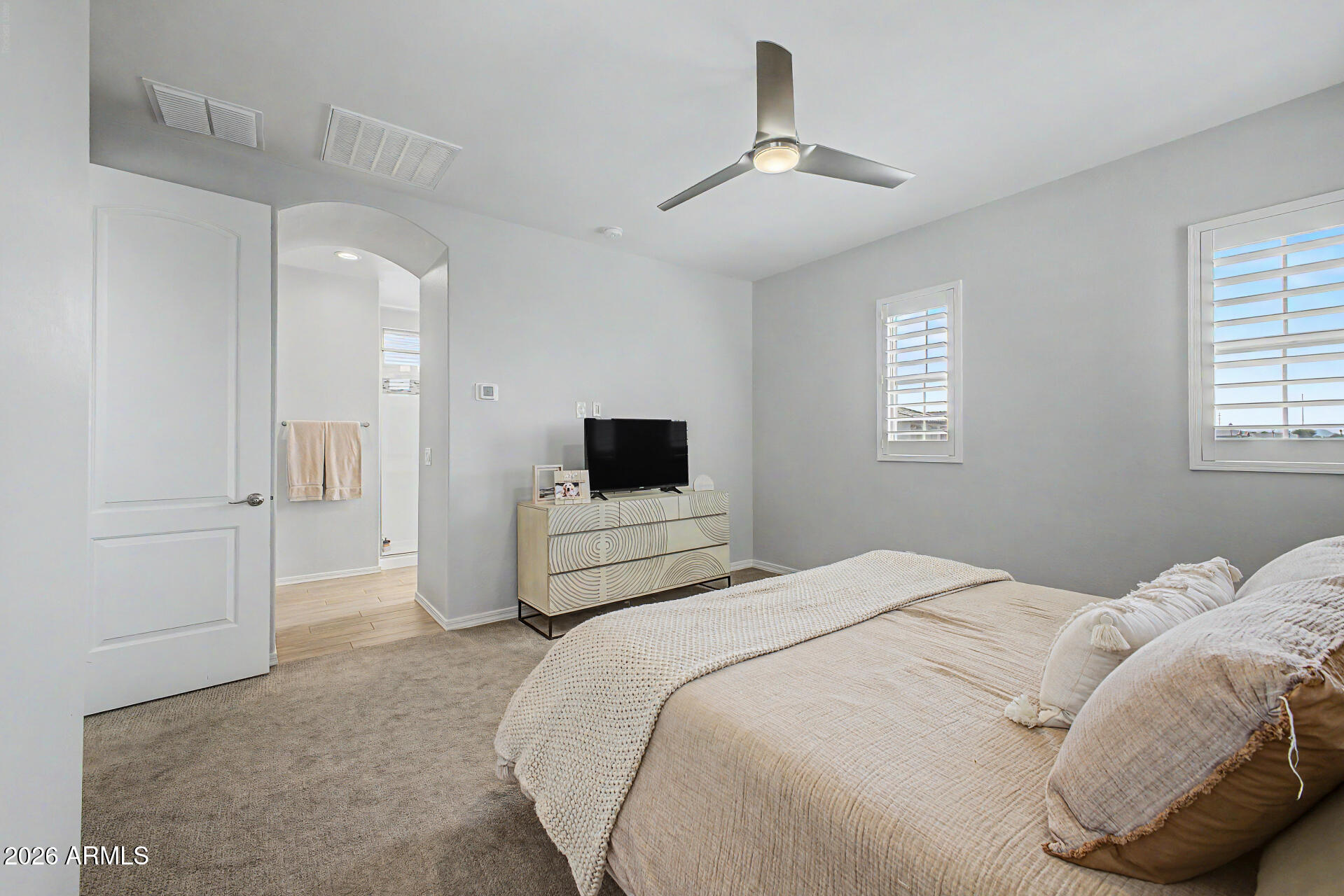 2583 South Entwistle Street Gilbert, AZ 85295 - Photo 14 of 42 a bedroom with a bed and a television