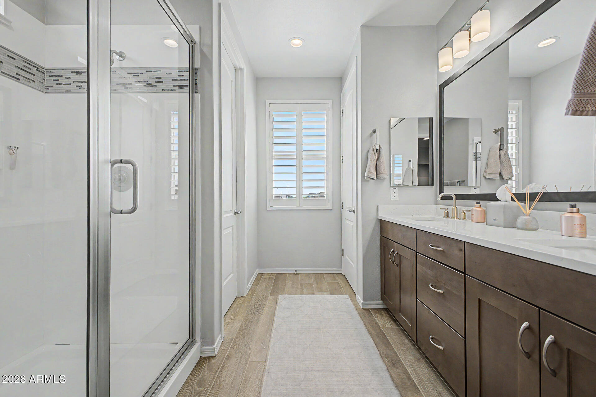 2583 South Entwistle Street Gilbert, AZ 85295 - Photo 16 of 42 a spacious bathroom with a shower a sink and a mirror