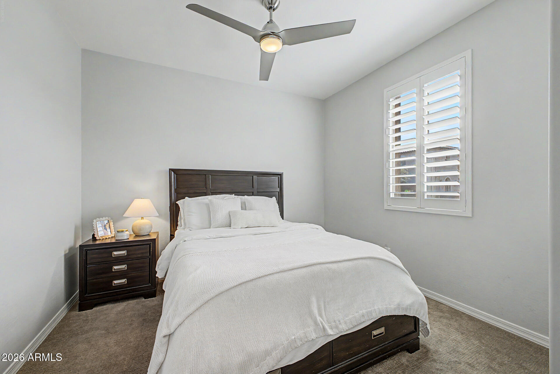 2583 South Entwistle Street Gilbert, AZ 85295 - Photo 27 of 42 a bedroom with a bed and a window