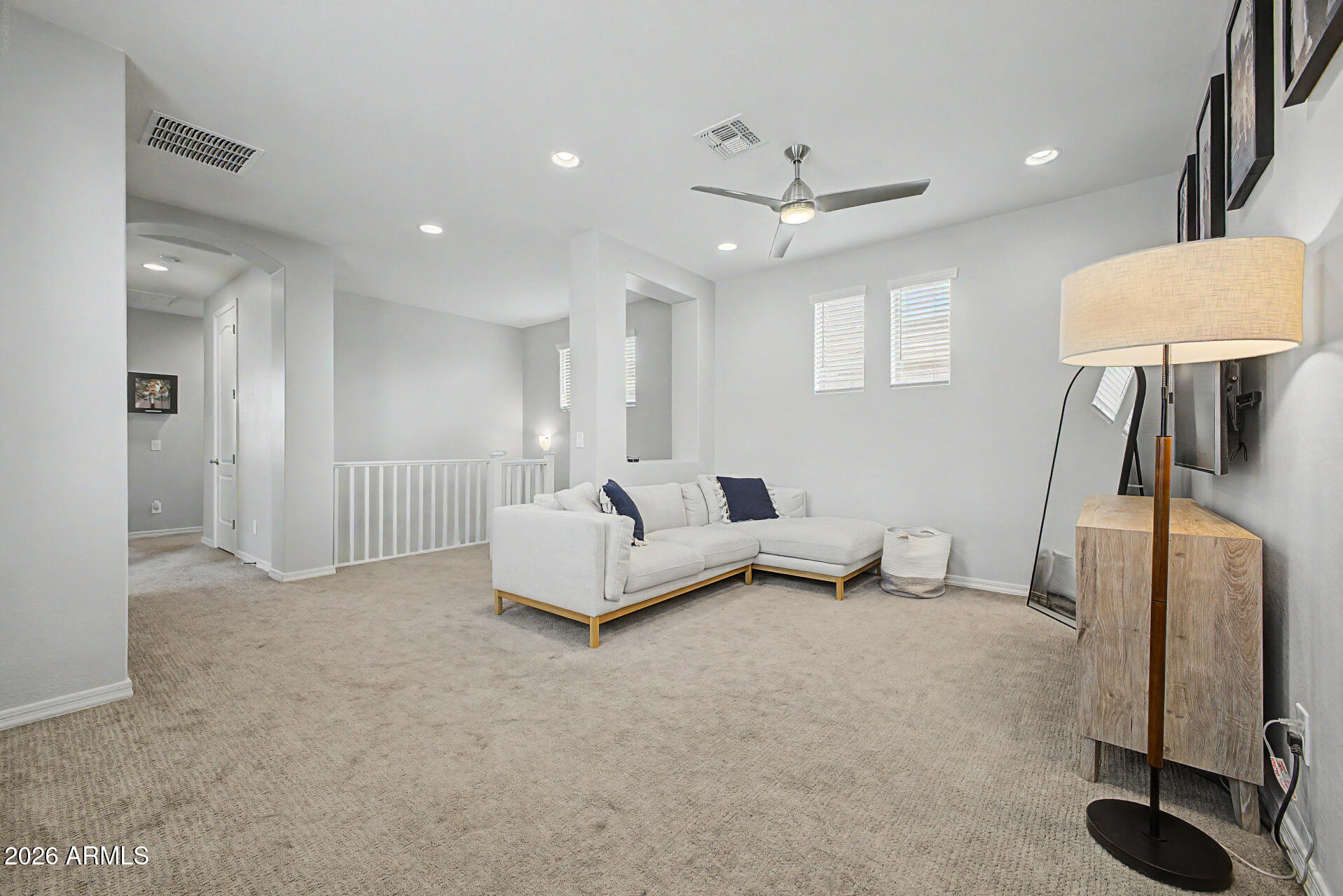 2583 South Entwistle Street Gilbert, AZ 85295 - Photo 34 of 42 a spacious bedroom with a bed and a lamp