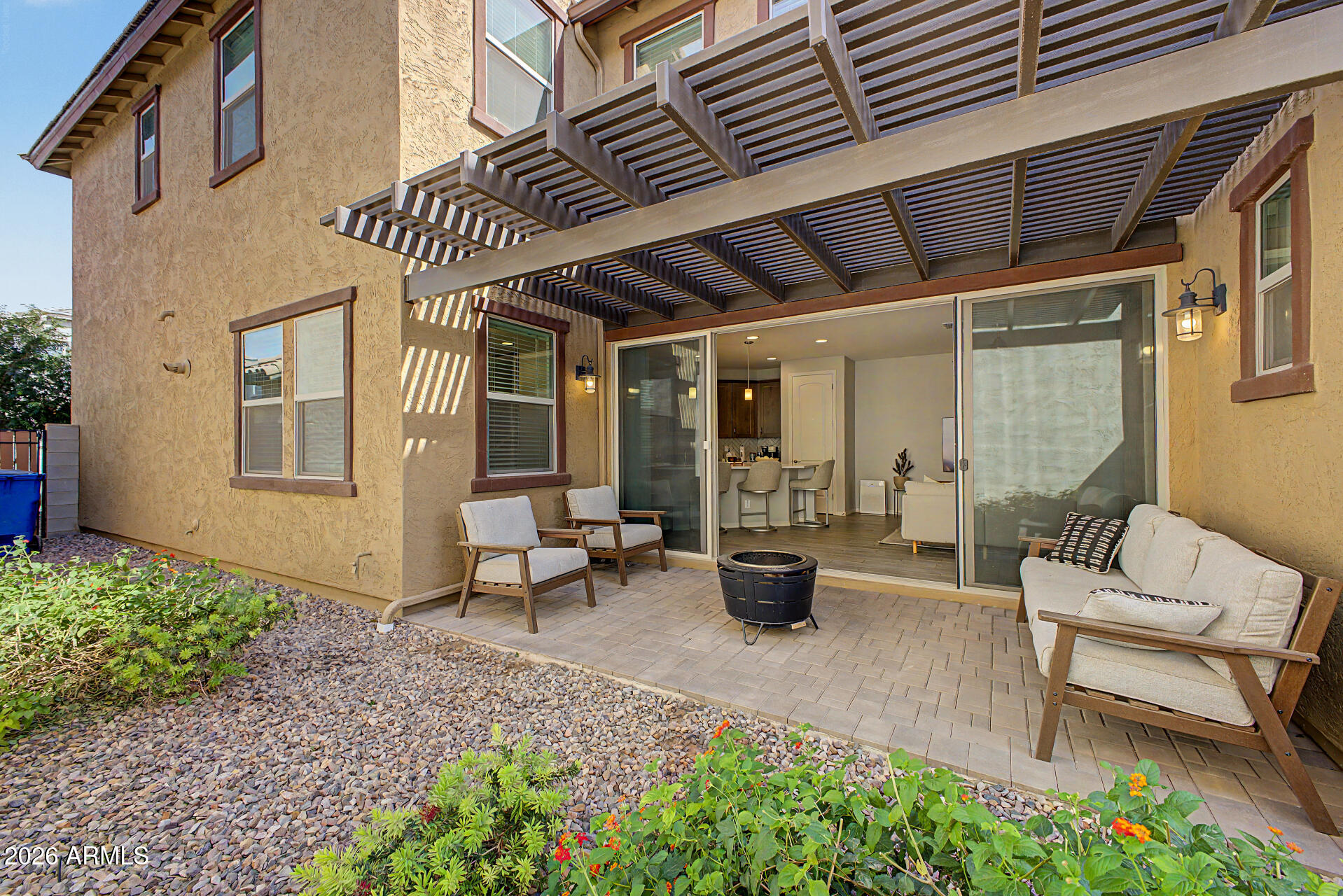 2583 South Entwistle Street Gilbert, AZ 85295 - Photo 41 of 42 a view of a patio with couches table and chairs and potted plants