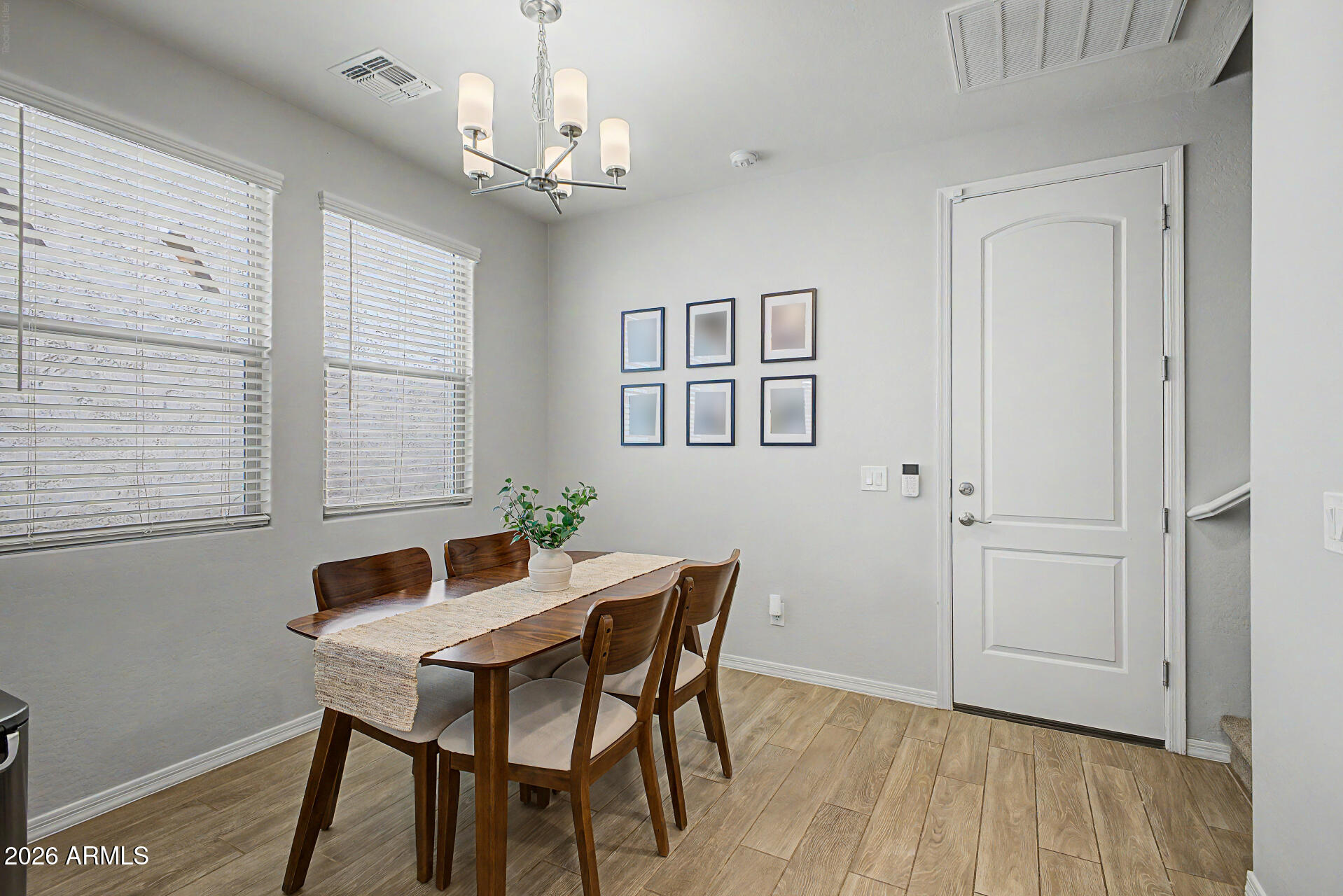 2583 South Entwistle Street Gilbert, AZ 85295 - Photo 7 of 42 a view of a dining room with furniture window and wooden floor