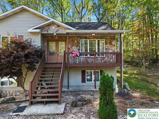 a view of a livingroom with wooden floor and a fireplace