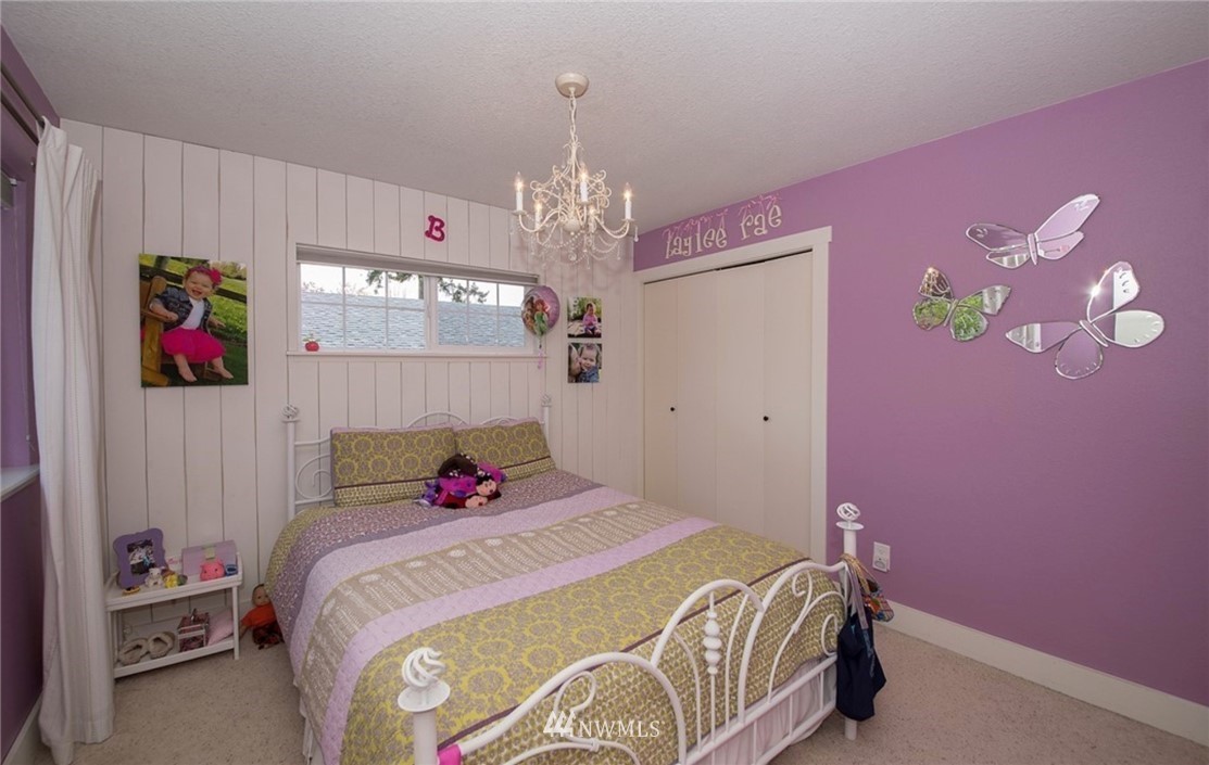 205 West Wiser Lake Road Ferndale, WA 98248 - Photo 14 of 24 a bed room with a bed and a chandelier