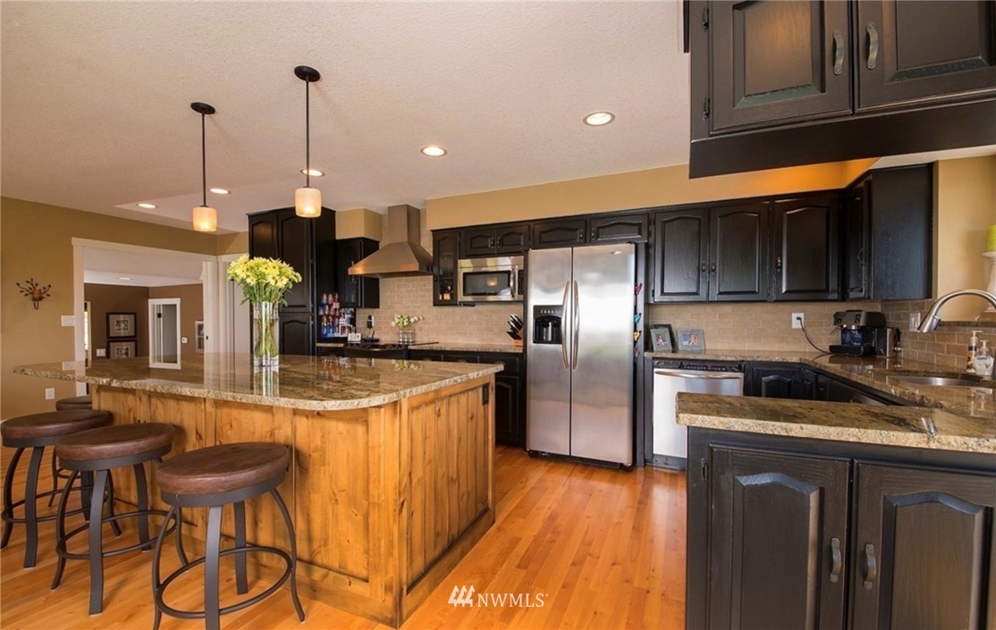205 West Wiser Lake Road Ferndale, WA 98248 - Photo 8 of 24 a kitchen with stainless steel appliances granite countertop a sink a stove and refrigerator