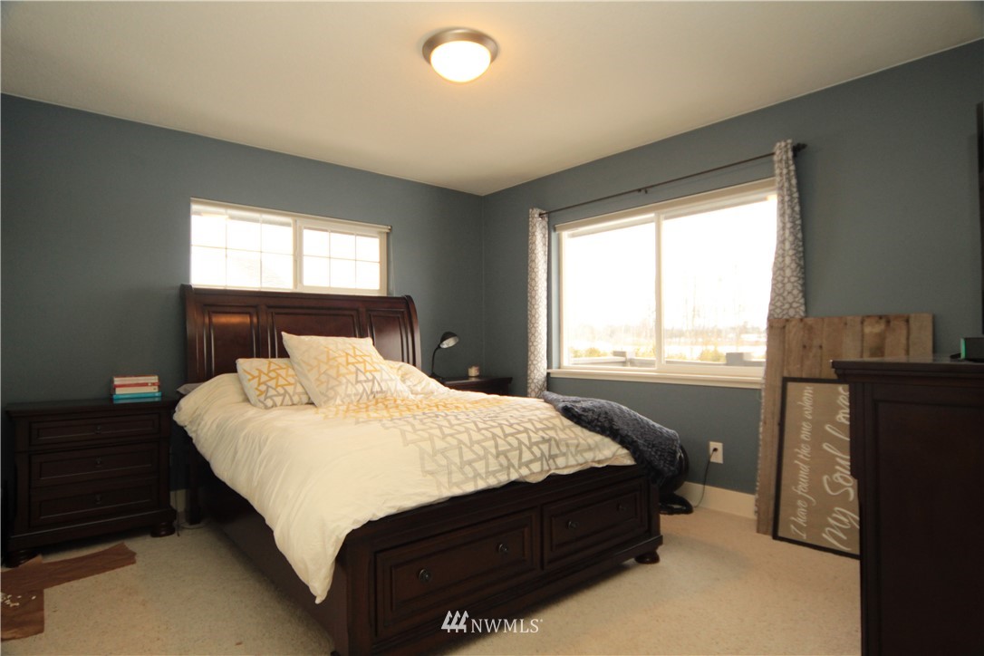 205 West Wiser Lake Road Ferndale, WA 98248 - Photo 10 of 24 a bed sitting in a bedroom next to a window