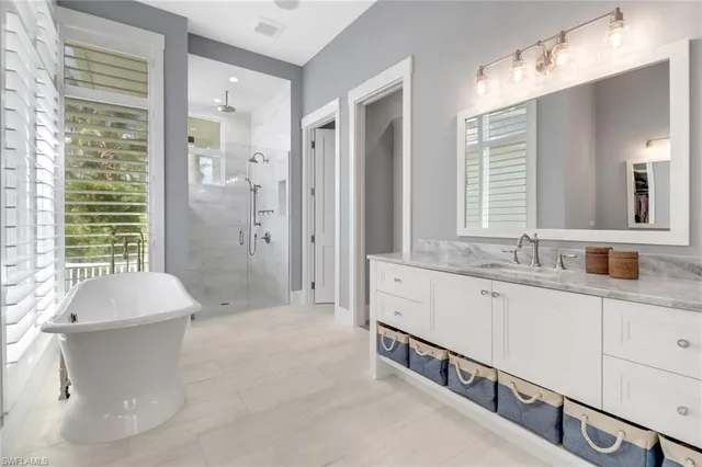 a spacious bathroom with double vanity a mirror a bathtub and shower