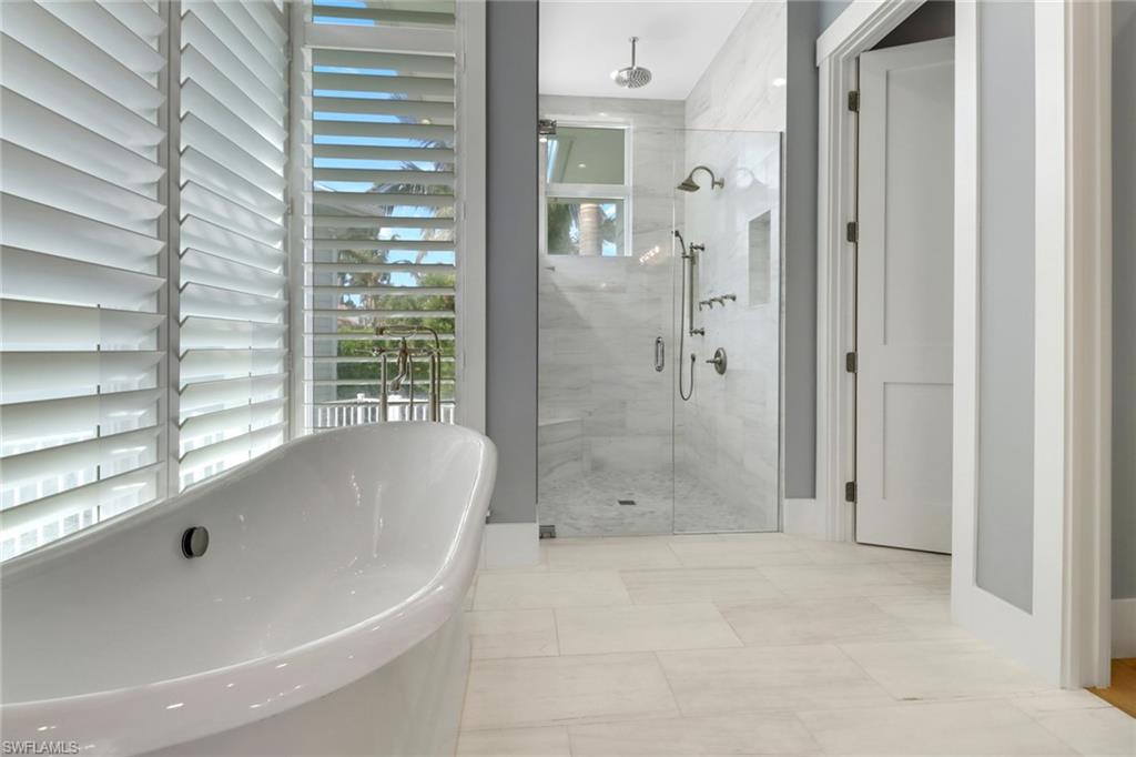 1300 Cobia Court Naples, FL 34102 - Photo 15 of 41 a bathroom with a bathtub and shower