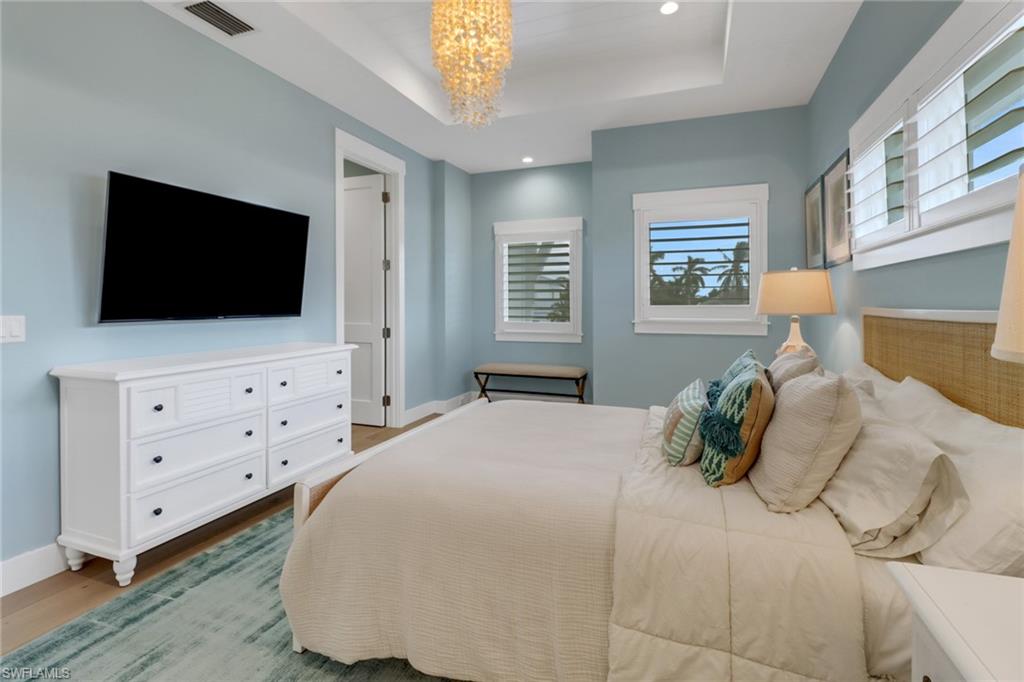 1300 Cobia Court Naples, FL 34102 - Photo 21 of 41 a bedroom with a bed and a flat screen tv
