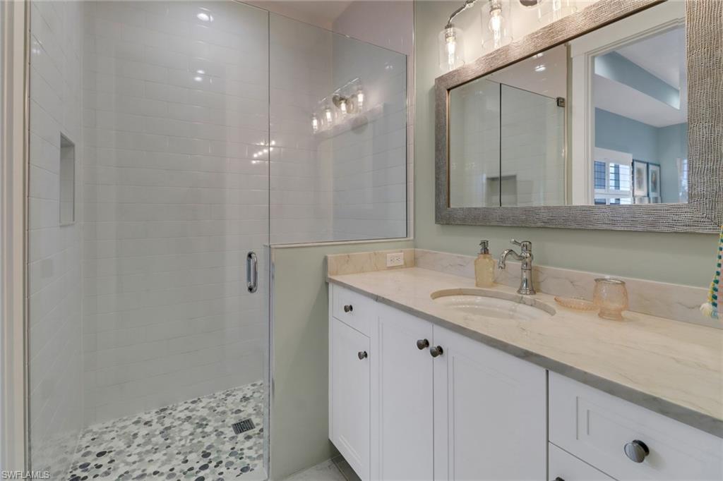 1300 Cobia Court Naples, FL 34102 - Photo 22 of 41 a bathroom with a sink and a mirror
