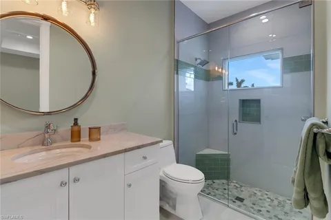 a bathroom with a sink a toilet and a mirror