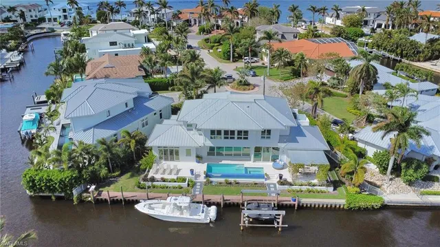 an aerial view of a house with yard swimming pool and outdoor seating