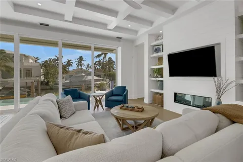 a living room with fireplace furniture and a flat screen tv