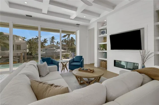 a living room with fireplace furniture and a flat screen tv