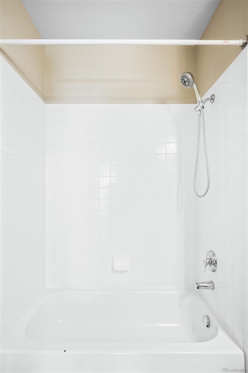 2240 South Vaughn Way, Unit 201 Aurora, CO 80014 - Photo 26 of 34 a bathroom with a shower and a bath tub