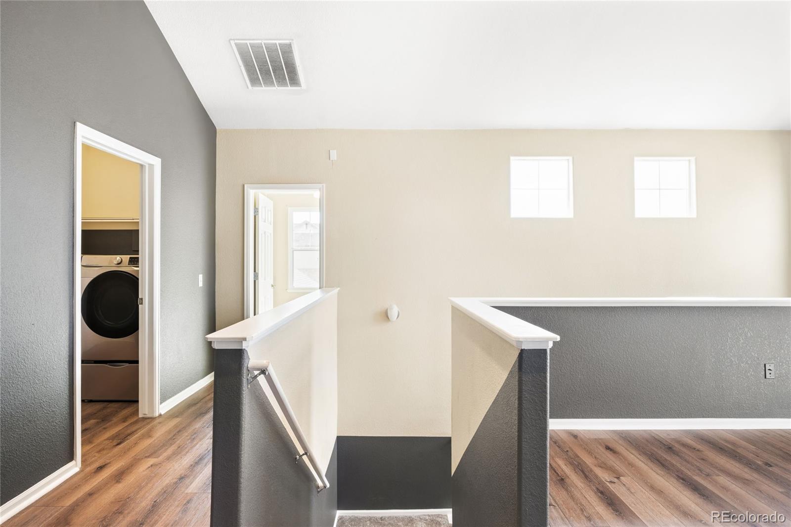 2240 South Vaughn Way, Unit 201 Aurora, CO 80014 - Photo 6 of 34 a view of a kitchen with wooden floor and staircase