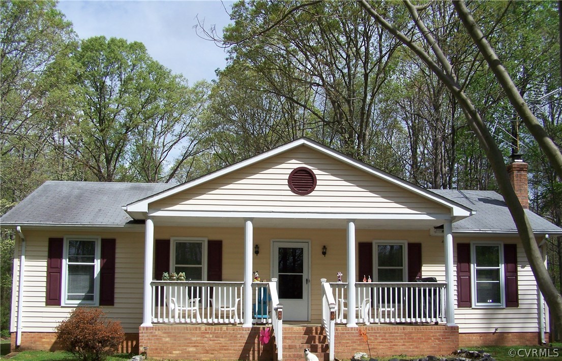 2383 Sizer Road Beaverdam, VA 23015 - Photo 1 of 29 a view of a white house with large windows and a large tree