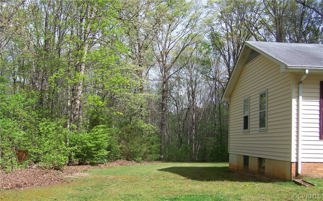 2383 Sizer Road Beaverdam, VA 23015 - Photo 2 of 29 a view of a yard in front of a house with plants and large tree