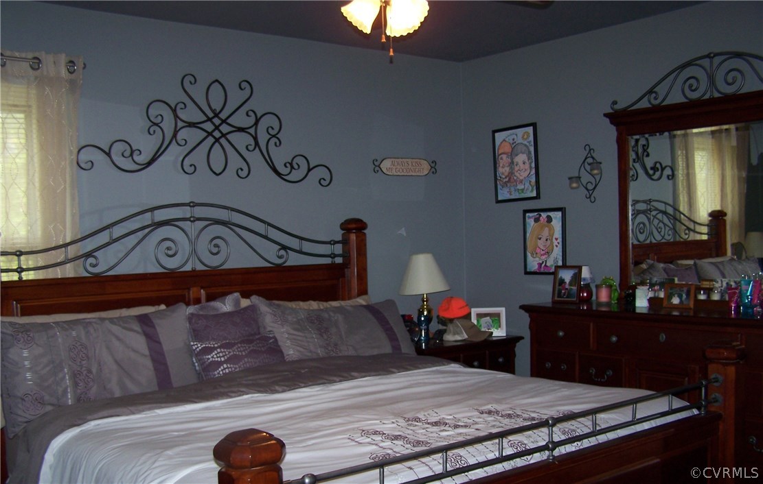 2383 Sizer Road Beaverdam, VA 23015 - Photo 23 of 29 a bedroom with a bed and a chandelier