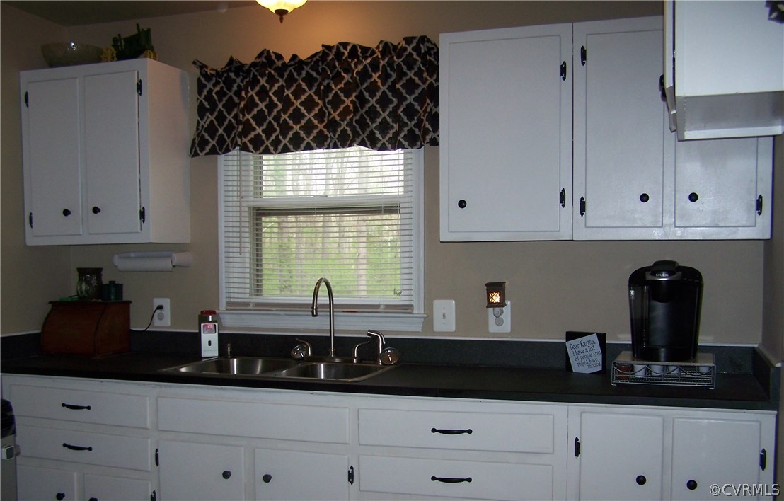 2383 Sizer Road Beaverdam, VA 23015 - Photo 6 of 29 a kitchen with white cabinets and a sink