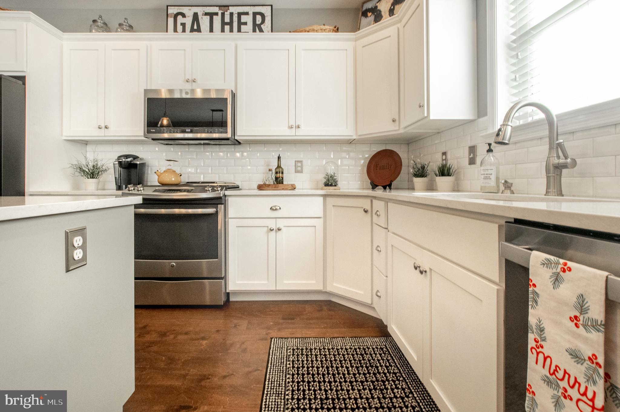 1247 South Red Maple Way Downingtown, PA 19335 - Photo 11 of 32 a kitchen with stainless steel appliances a stove a sink a refrigerator and cabinets