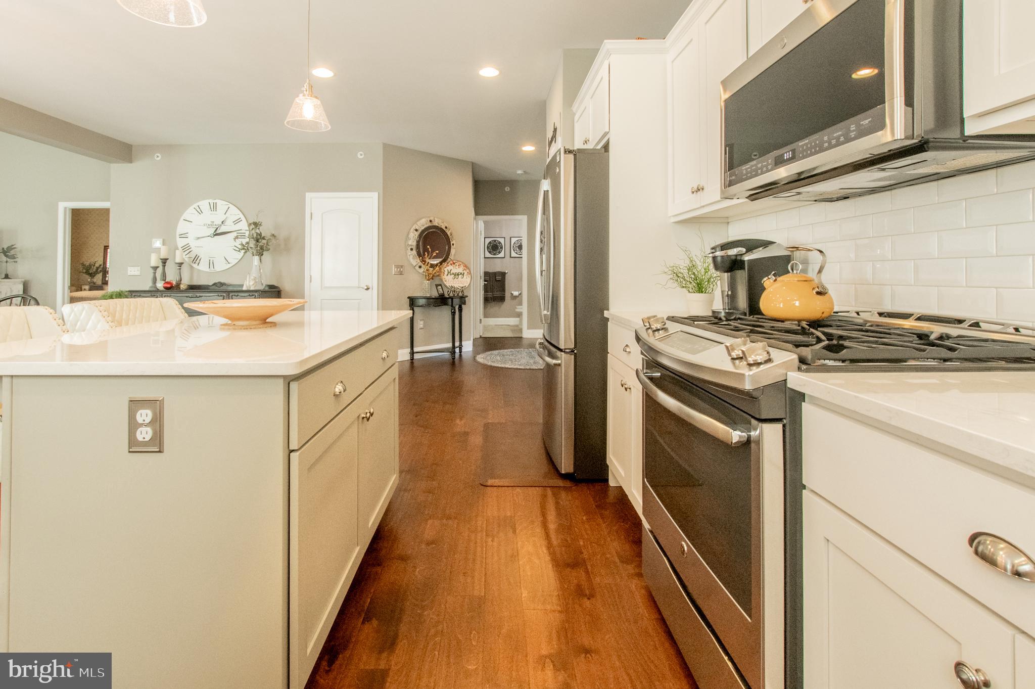 1247 South Red Maple Way Downingtown, PA 19335 - Photo 12 of 32 a kitchen with kitchen island a sink stove and refrigerator