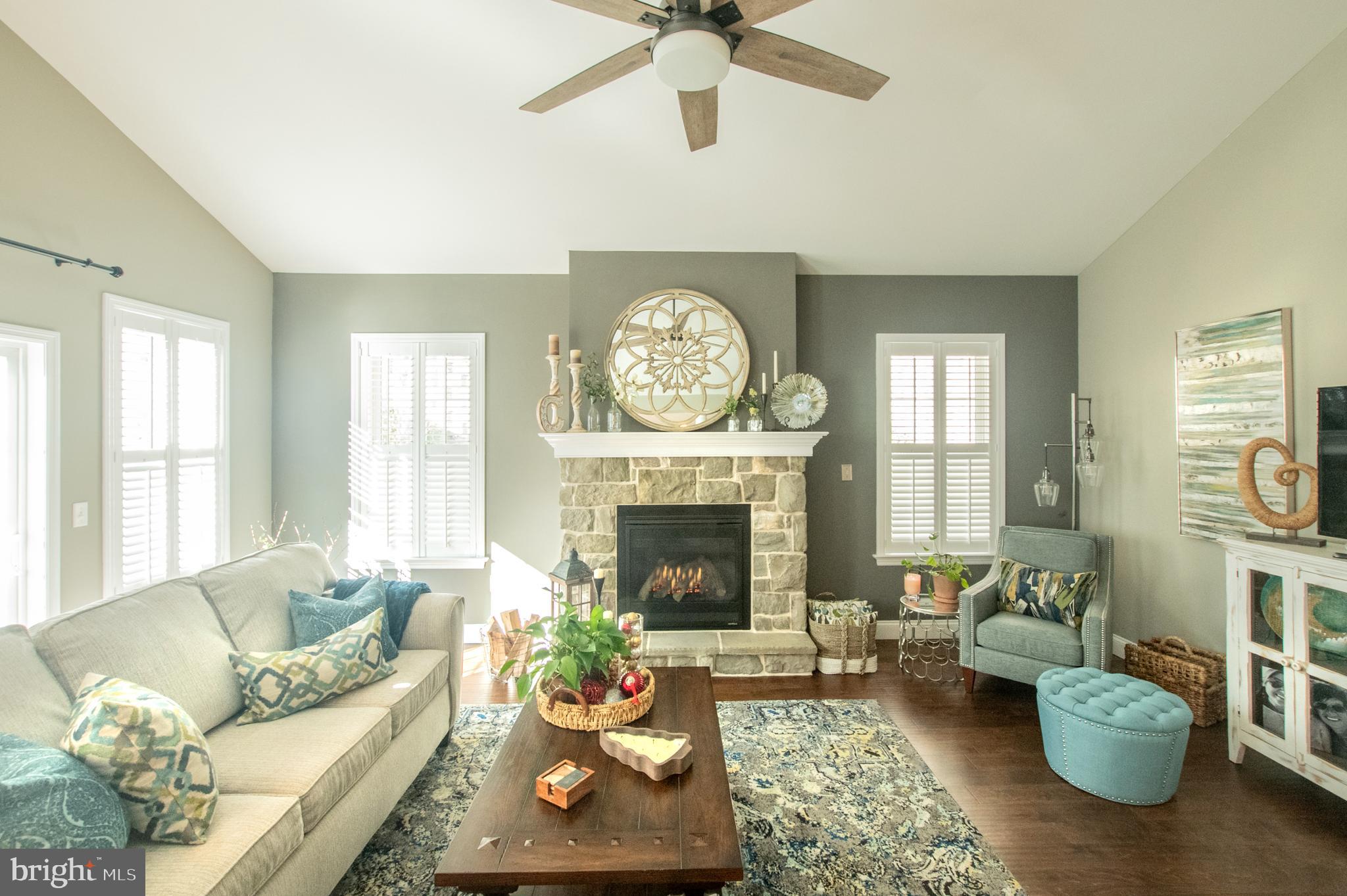 1247 South Red Maple Way Downingtown, PA 19335 - Photo 21 of 32 a living room with furniture a fireplace and a chandelier