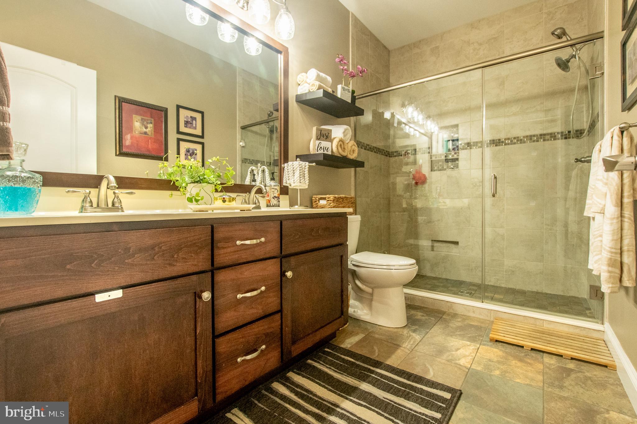 1247 South Red Maple Way Downingtown, PA 19335 - Photo 25 of 32 a bathroom with a double vanity sink toilet mirror and shower