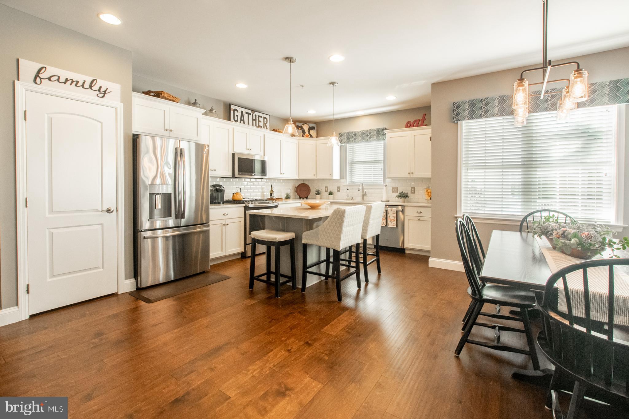 1247 South Red Maple Way Downingtown, PA 19335 - Photo 9 of 32 a view of a dining room with furniture window and wooden floor