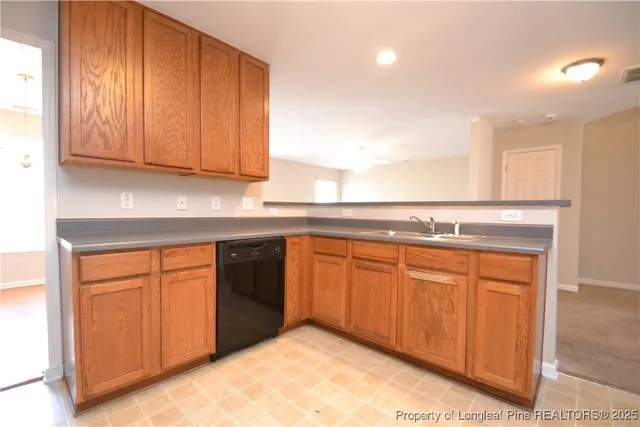 a kitchen with stainless steel appliances granite countertop a sink and cabinets