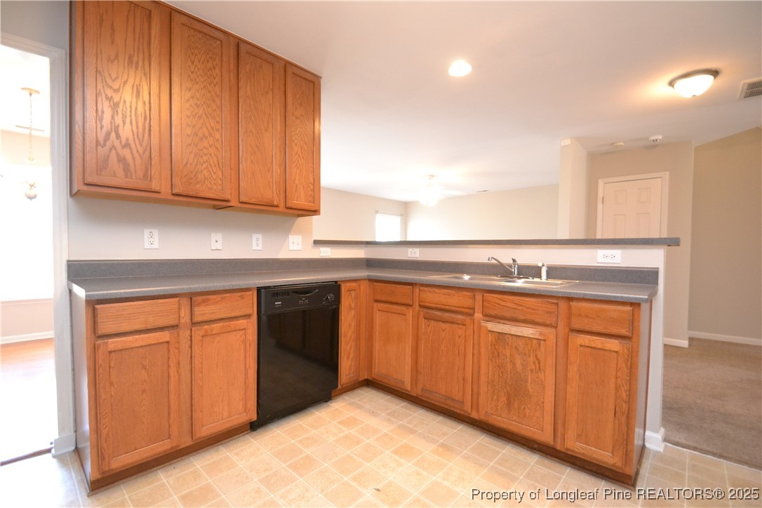 1428 Cricket Ridge Drive Raleigh, NC 27610 - Photo 11 of 47 a kitchen with stainless steel appliances granite countertop a sink and cabinets