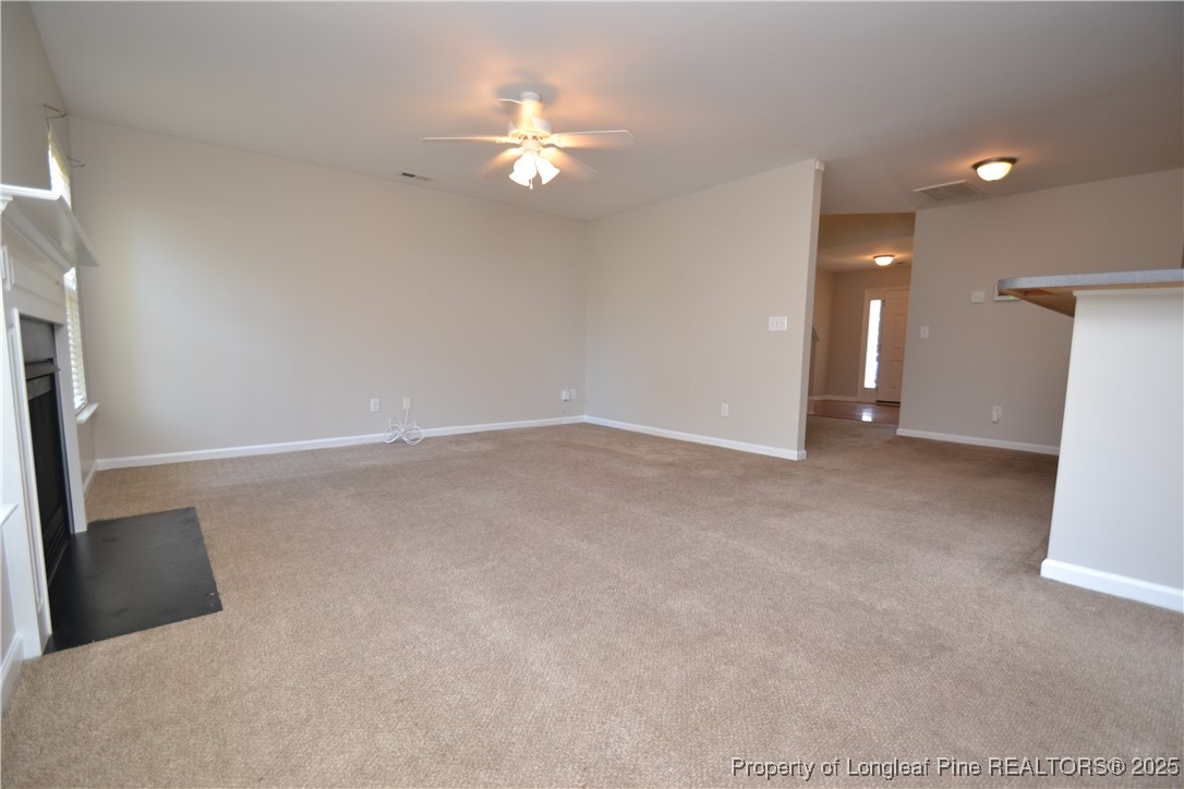 1428 Cricket Ridge Drive Raleigh, NC 27610 - Photo 15 of 47 an empty room with chandelier fan and refrigerator