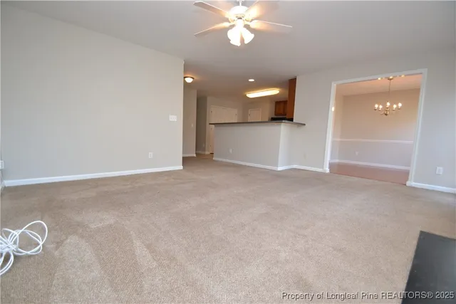 an empty room with fan and entrance