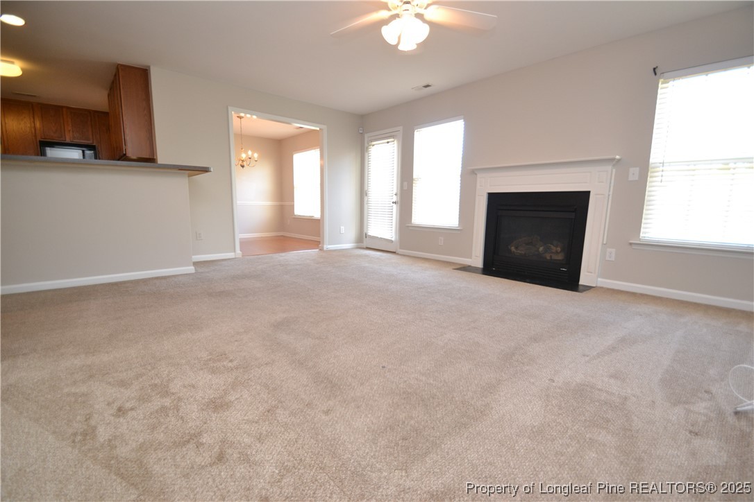 1428 Cricket Ridge Drive Raleigh, NC 27610 - Photo 17 of 47 a view of an empty room with a fireplace and a window