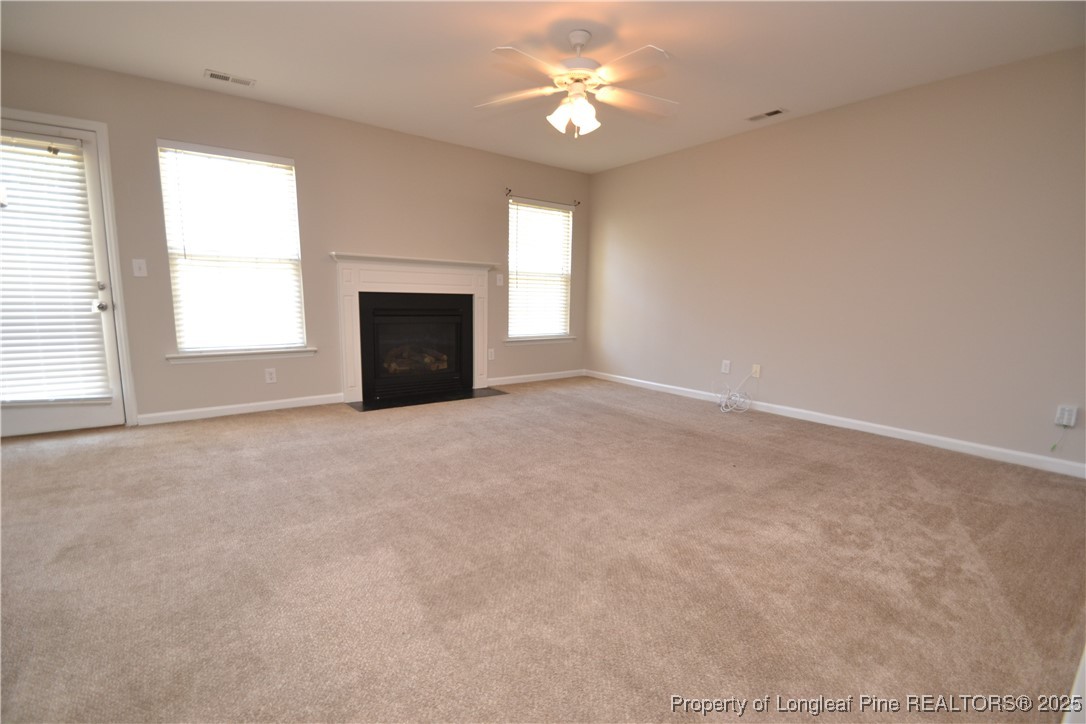 1428 Cricket Ridge Drive Raleigh, NC 27610 - Photo 18 of 47 an empty room with windows and fireplace