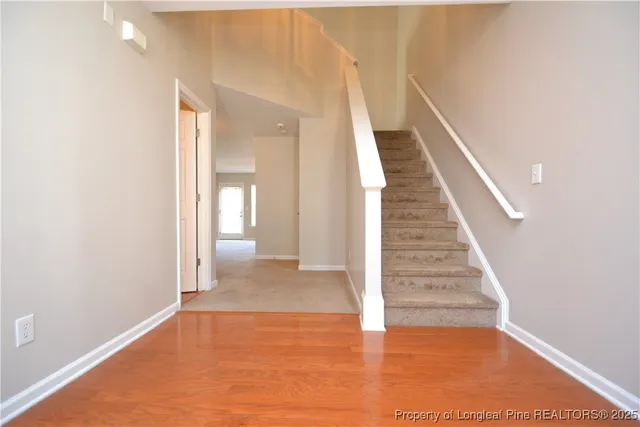 a view of entryway and hall with wooden floor