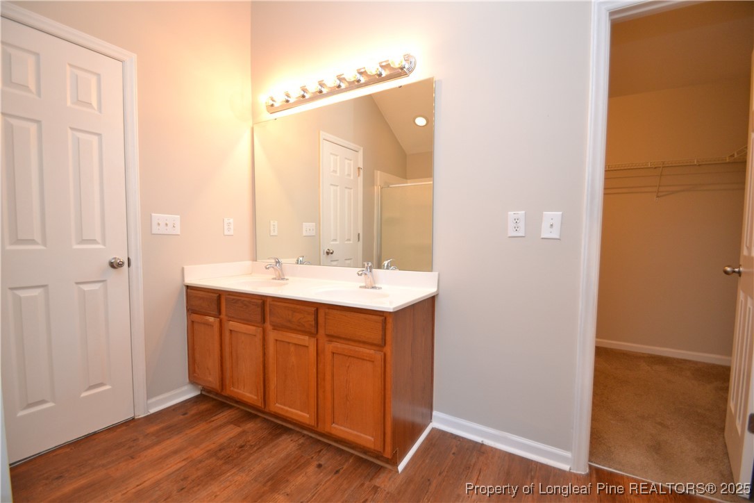 1428 Cricket Ridge Drive Raleigh, NC 27610 - Photo 30 of 47 a bathroom with a sink and a mirror