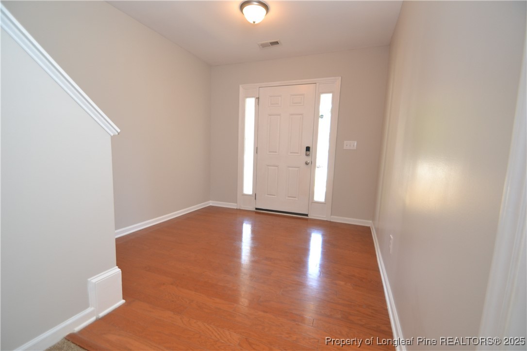 1428 Cricket Ridge Drive Raleigh, NC 27610 - Photo 3 of 47 a view of an empty room with wooden floor