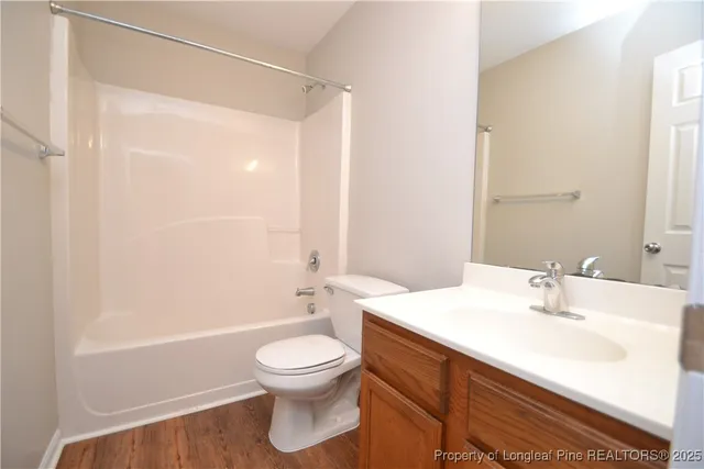 a bathroom with a toilet a sink and a mirror