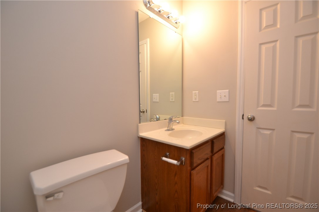 1428 Cricket Ridge Drive Raleigh, NC 27610 - Photo 39 of 47 a bathroom with a toilet a sink and a mirror