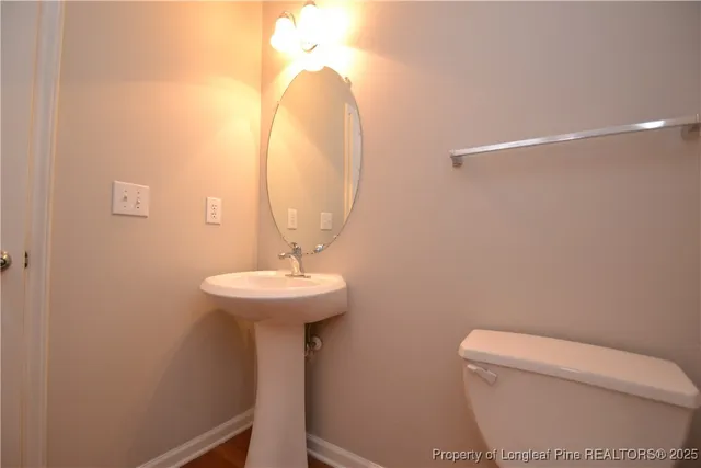 a bathroom with a sink a mirror and toilet
