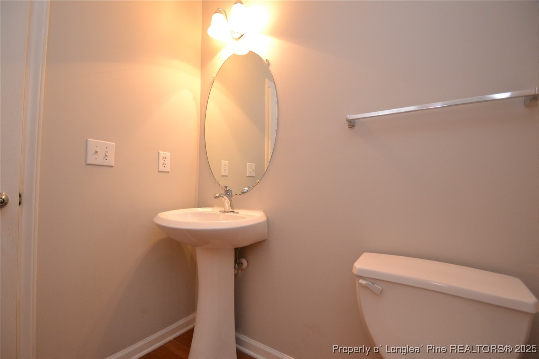 1428 Cricket Ridge Drive Raleigh, NC 27610 - Photo 4 of 47 a bathroom with a sink a mirror and toilet
