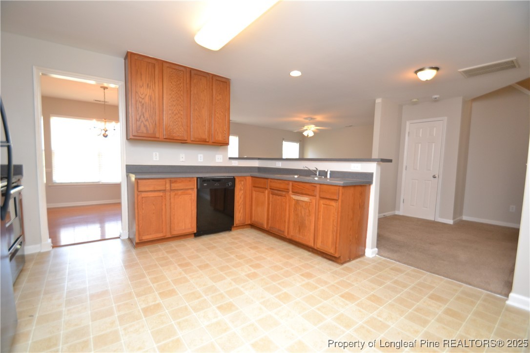 1428 Cricket Ridge Drive Raleigh, NC 27610 - Photo 7 of 47 a kitchen with stainless steel appliances granite countertop a stove a sink and a refrigerator