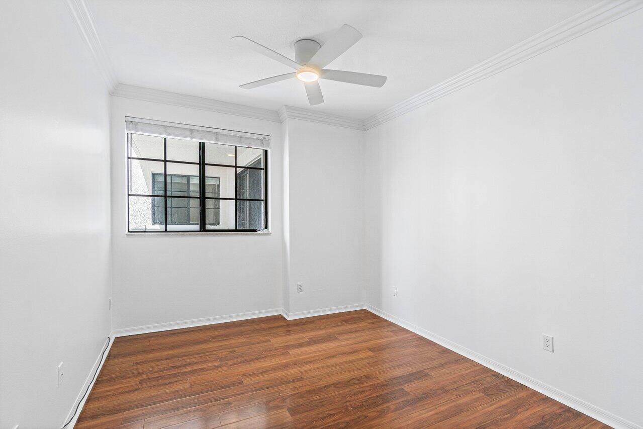 233 South Federal Highway, Unit 410 Boca Raton, FL 33432 - Photo 16 of 50 a view of empty room with wooden floor and fan